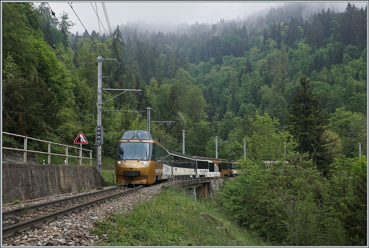 Der GoldenPass MOB Panoramic Zweisimmen - Montreux PE 2111 mit dem Ast 152 an der Spitze, der GDe 4/4 6004  Interlaken  als Zug-Lok und dem Ast 116 am Zugschluss zeigt sich kurz vor nach Sendy-Sollard.

16. Mai 2020