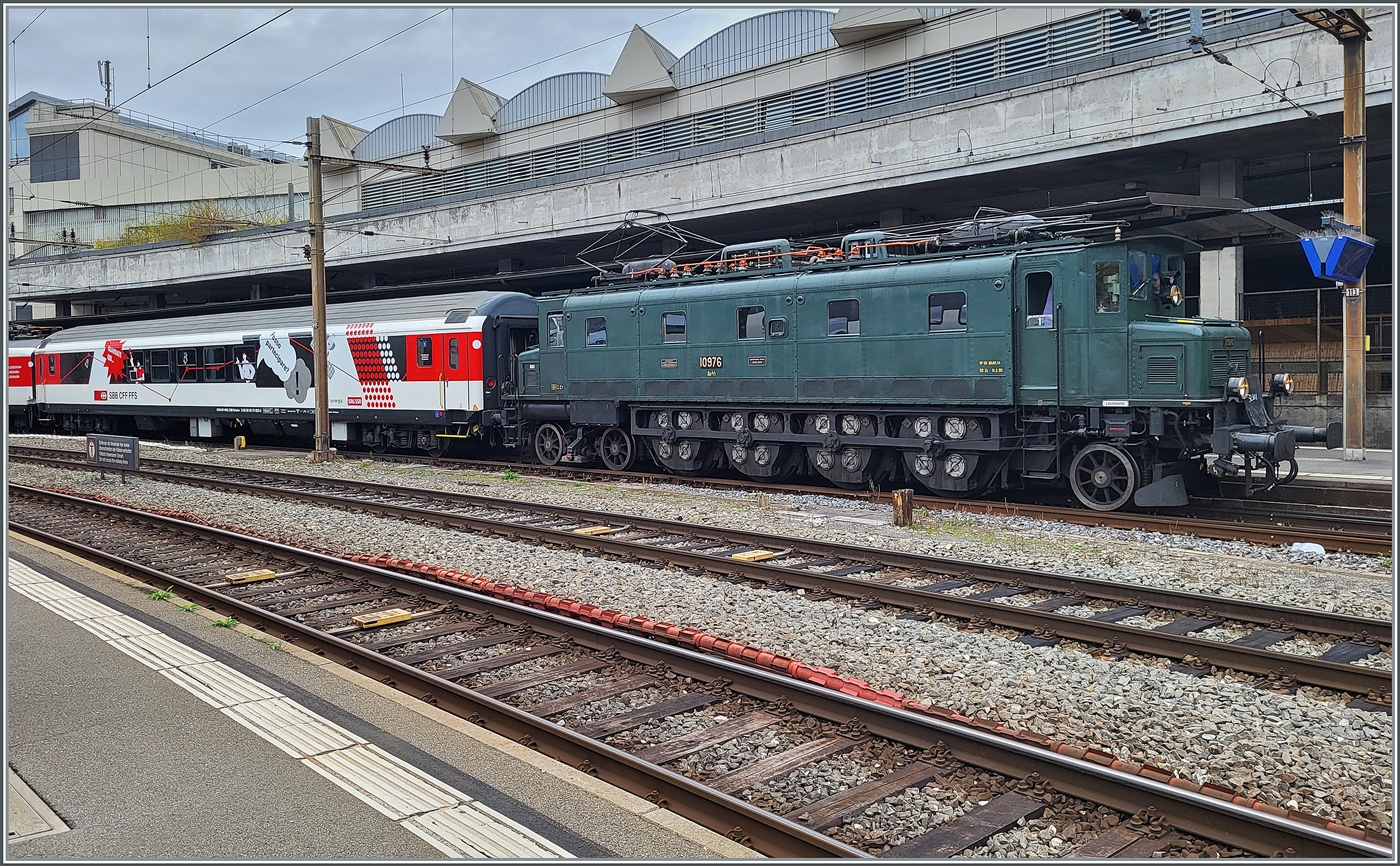 Auf Gleis 1 in Lausanne wartet die SBB Historic Ae 4/7 10976 mit ihrem Schulzug auf die Abfahrt. Die Lok wurde 1931 abgeliefert und stand bis 1995 im aktiven Dienst und wurde dann nach 64 Einsatzjahren als SBB Historic Lok aufgenommen. Der SBB Schulzug wird traditionell von  Altbauloks  befördert, die passen zwar eher wenig zum Zug, bieten aber die Gelegenheit, dass die Loks bewegt werden und Bahnfotografen sie verewigen können. 1. Nov. 2025