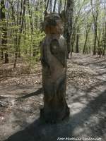 Wolfsskulptur aus Holz in einem Wald in Halle (Saale) am 23.4.15