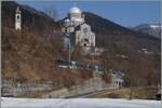 Vor dem Hintergrund der m�chtigen Wahlfahrskirche von Re ist eine SSIF Panorama-Zug auf dem Weg von Domodossola nach Locarno. 

19. M�rz 2015