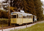 TN/TRN: Standard Motorwagen Be 4/4 582 + C2 1 (ehemals Pferdebahn) auf der Stichstrecke nach Areuse-Cortaillod im Juni 1984.
